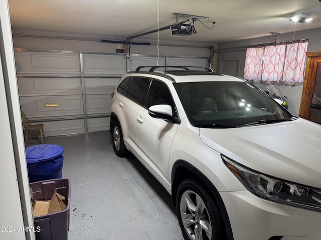 garage with a garage door opener and a carport