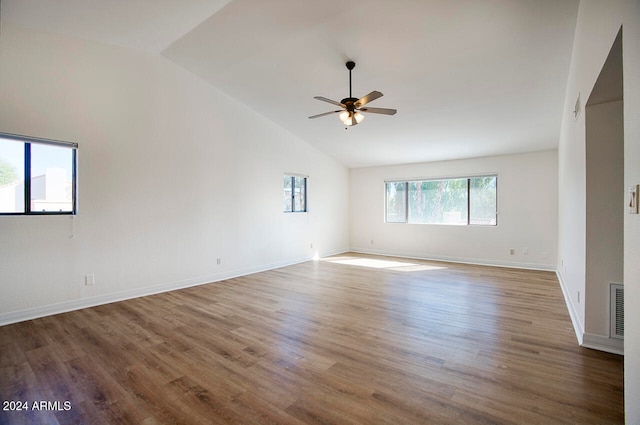 spare room with hardwood / wood-style floors, ceiling fan, and high vaulted ceiling