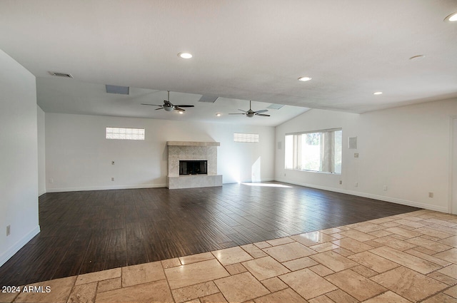 unfurnished living room featuring ceiling fan, light wood-type flooring, and vaulted ceiling