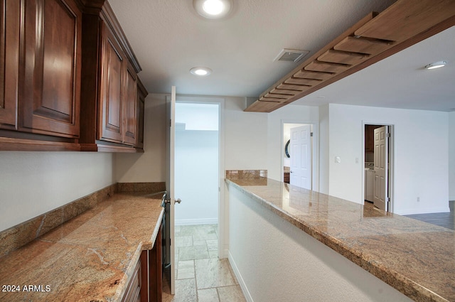 kitchen featuring light stone counters