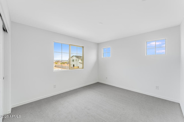 unfurnished bedroom with carpet flooring, a closet, and baseboards