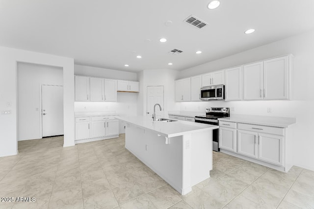 kitchen with a sink, visible vents, white cabinets, and appliances with stainless steel finishes