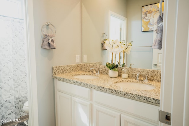 bathroom featuring vanity and toilet