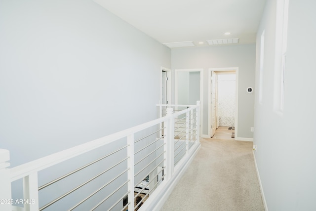 hallway with light colored carpet