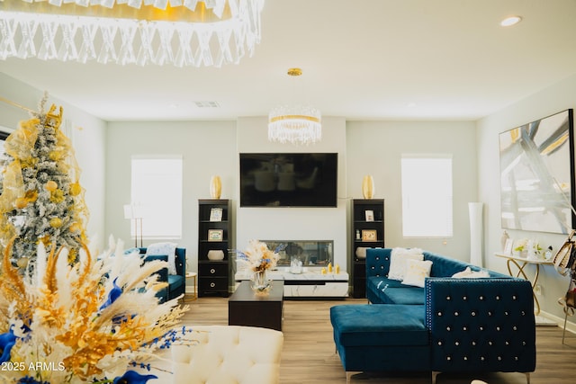 living room featuring hardwood / wood-style flooring and a notable chandelier