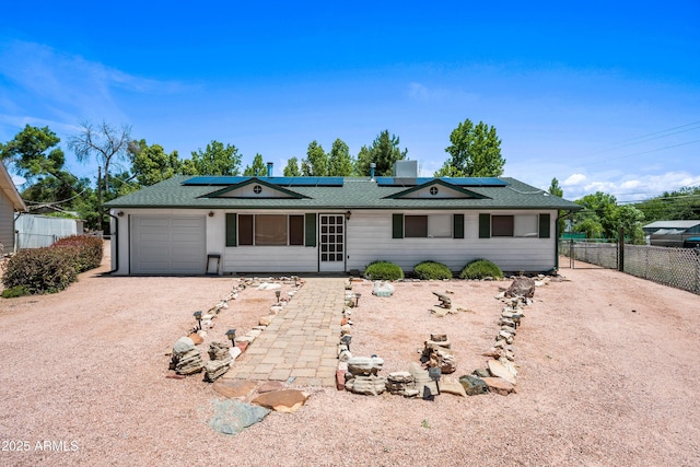 312 W Saddle Ln, Payson, AZ 85541 - ranch-style home featuring an attached garage, roof mounted solar panels, dirt driveway, and roof with shingles