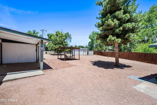312 W Saddle Ln, Payson, AZ 85541 - fenced backyard featuring a storage unit and a patio area