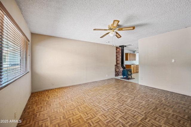 312 W Saddle Ln, Payson, AZ 85541 - spare room with a ceiling fan, a textured ceiling, and a wood stove