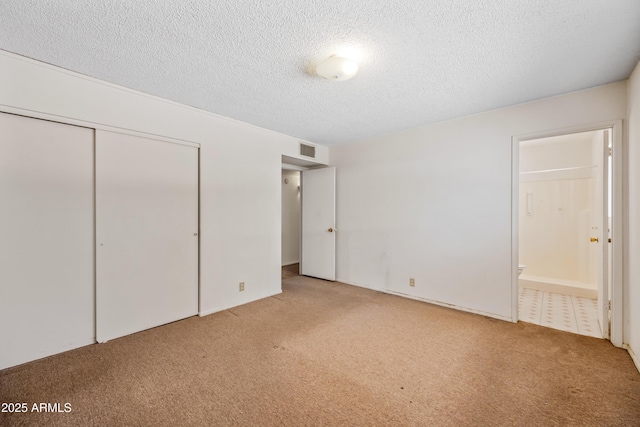 312 W Saddle Ln, Payson, AZ 85541 - unfurnished bedroom featuring carpet flooring, a textured ceiling, a closet, and connected bathroom