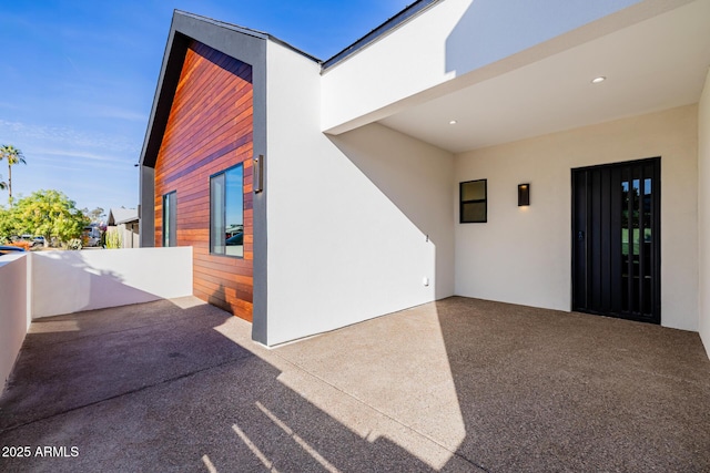 exterior space featuring a patio area and stucco siding