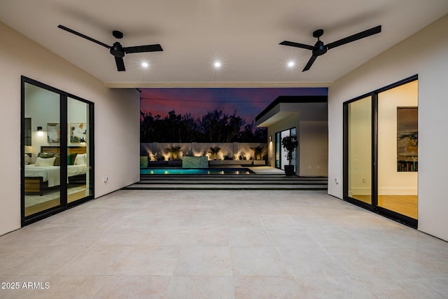 view of patio / terrace featuring a ceiling fan and a swimming pool