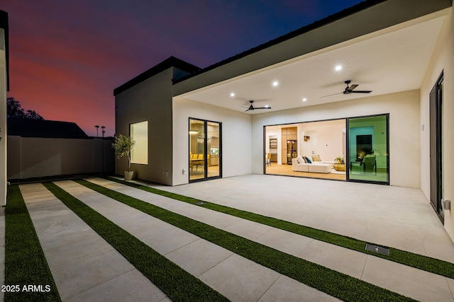 view of patio / terrace with ceiling fan and fence