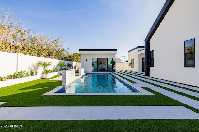 view of swimming pool featuring a fenced backyard, a lawn, a fenced in pool, and a patio