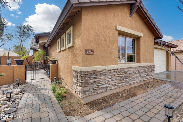 view of side of home featuring a garage