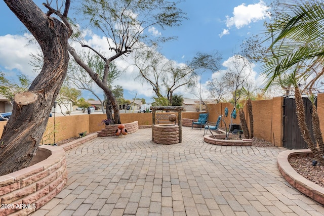 view of patio / terrace featuring an outdoor fire pit