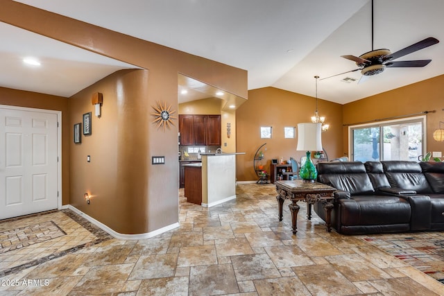 living room featuring ceiling fan with notable chandelier and vaulted ceiling