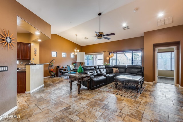 living room featuring high vaulted ceiling and ceiling fan with notable chandelier