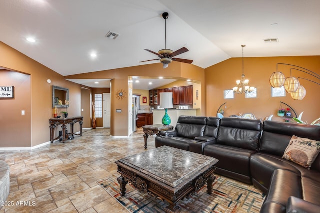 living room featuring lofted ceiling and ceiling fan with notable chandelier