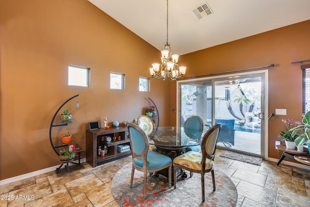 dining space featuring high vaulted ceiling and a chandelier