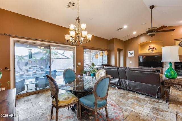 dining area with lofted ceiling and ceiling fan with notable chandelier