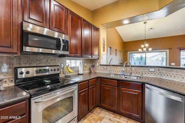 kitchen with pendant lighting, sink, an inviting chandelier, stainless steel appliances, and decorative backsplash