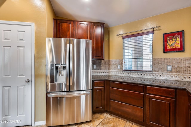 kitchen featuring tasteful backsplash and stainless steel fridge with ice dispenser