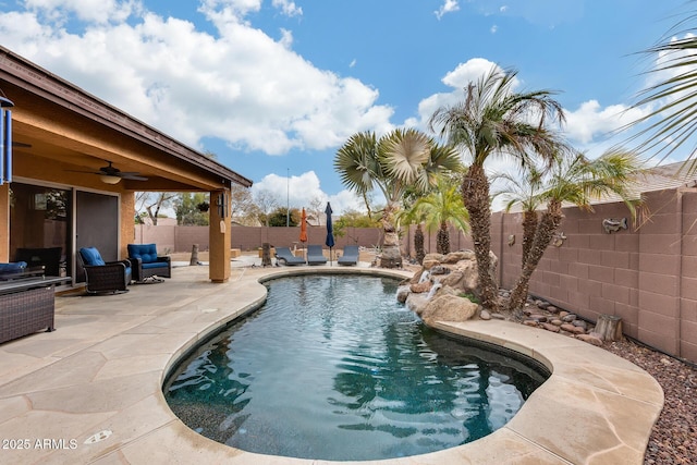 view of swimming pool featuring pool water feature, ceiling fan, and a patio