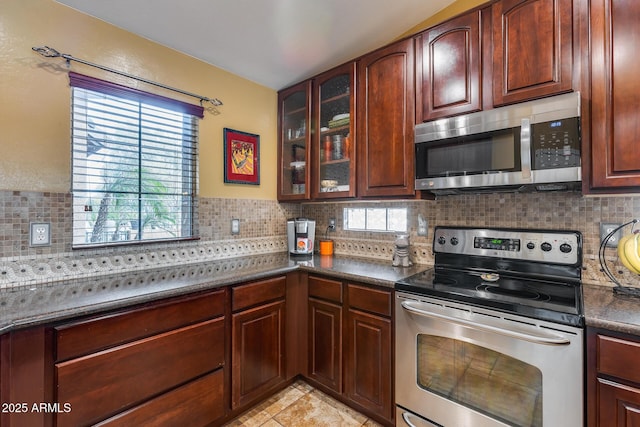 kitchen with stainless steel appliances, tasteful backsplash, and light tile patterned floors