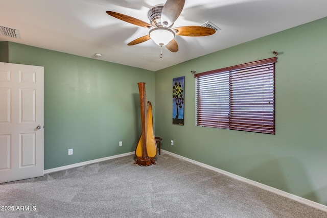 carpeted empty room featuring ceiling fan