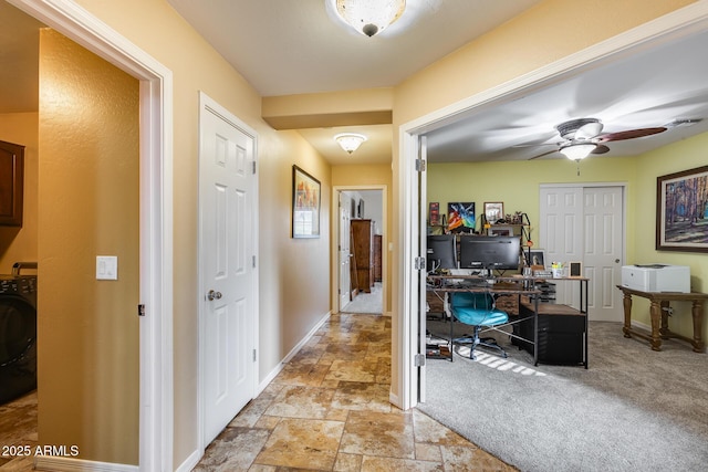 home office with ceiling fan, light colored carpet, and washer / clothes dryer