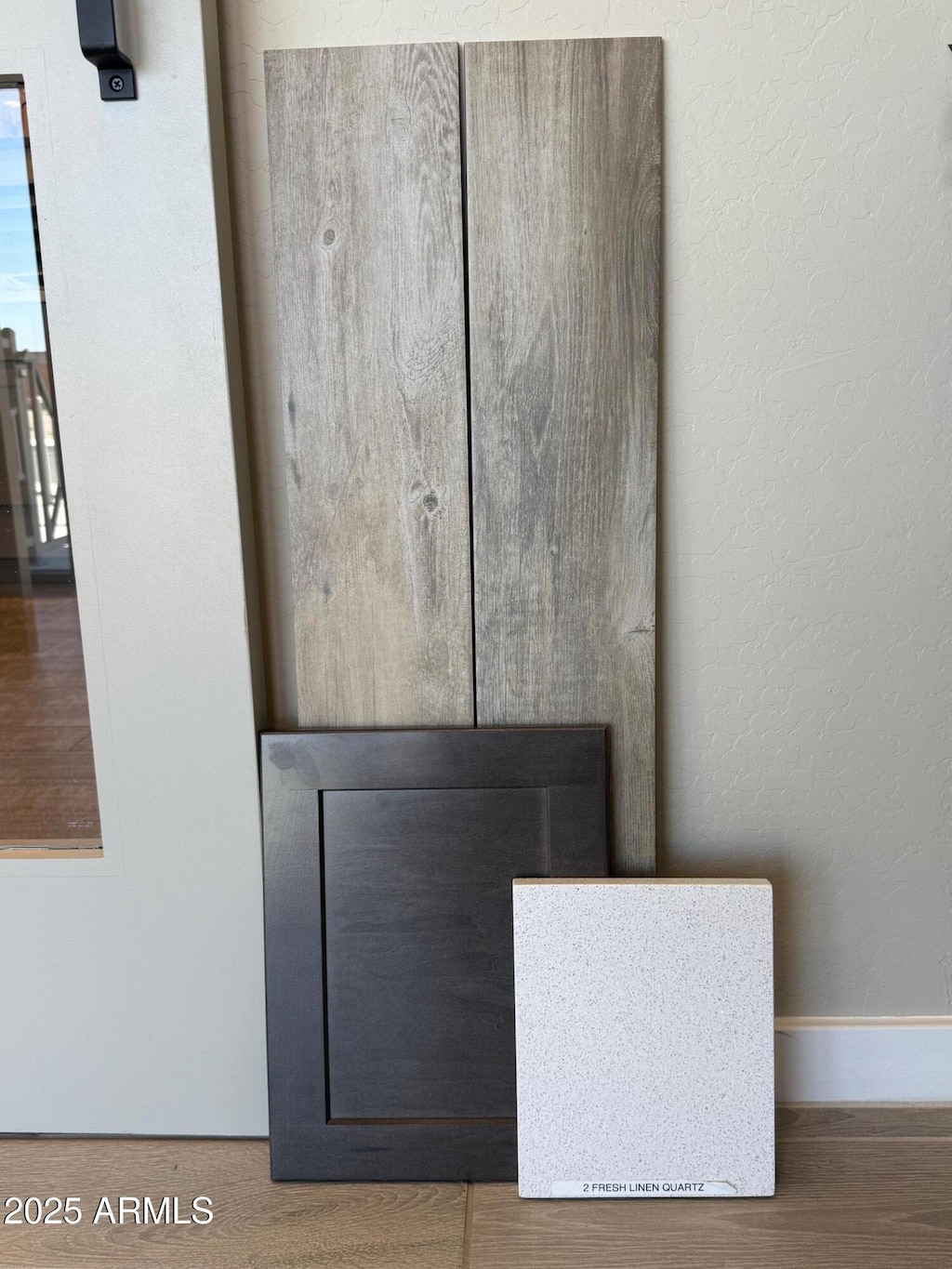 17309 W Puget Ave, Waddell, AZ 85355 - detailed view of baseboards, wood finished floors, and a textured wall