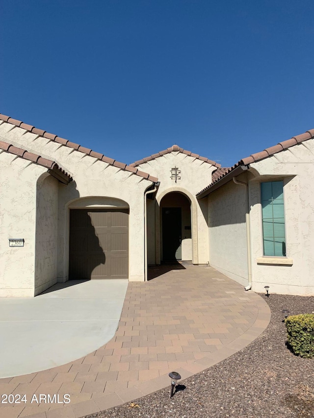 mediterranean / spanish-style home featuring a garage