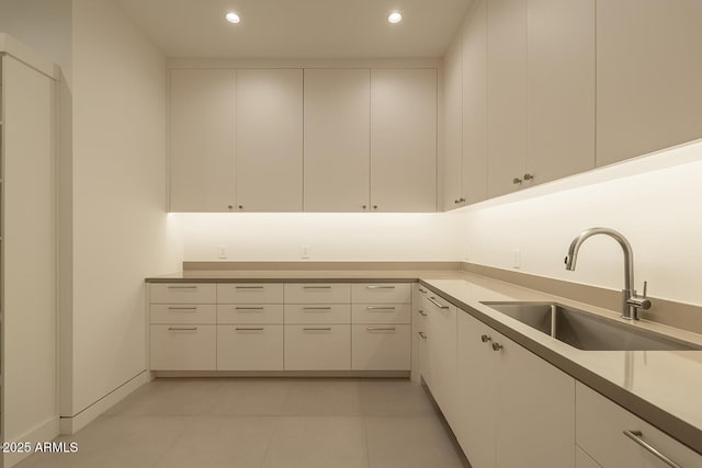 kitchen featuring a sink, recessed lighting, and white cabinetry