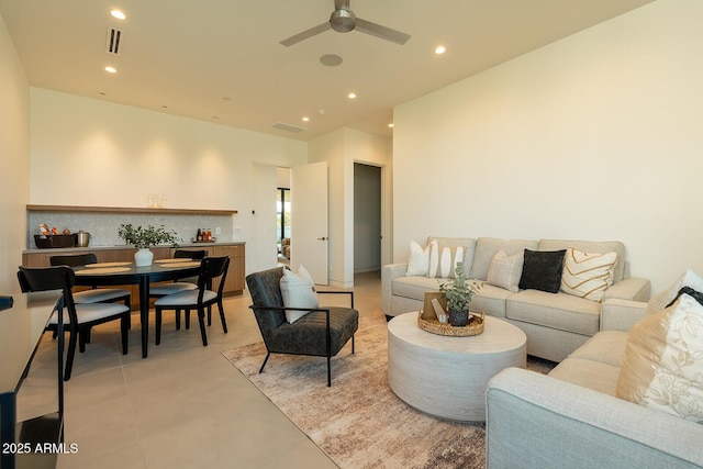 living area featuring recessed lighting, visible vents, and ceiling fan