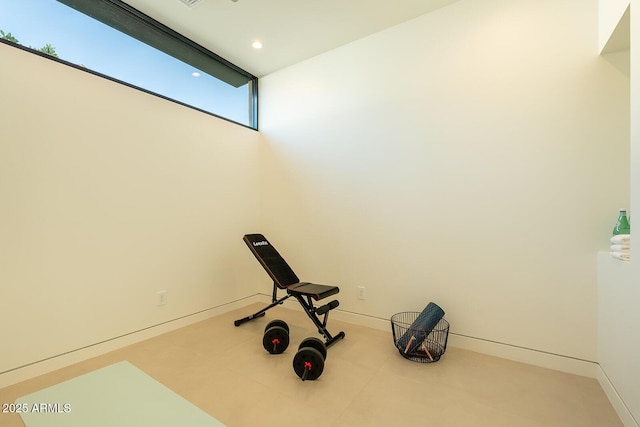 workout area featuring recessed lighting and baseboards