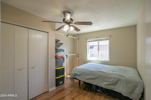 bedroom featuring ceiling fan, a closet, and hardwood / wood-style floors