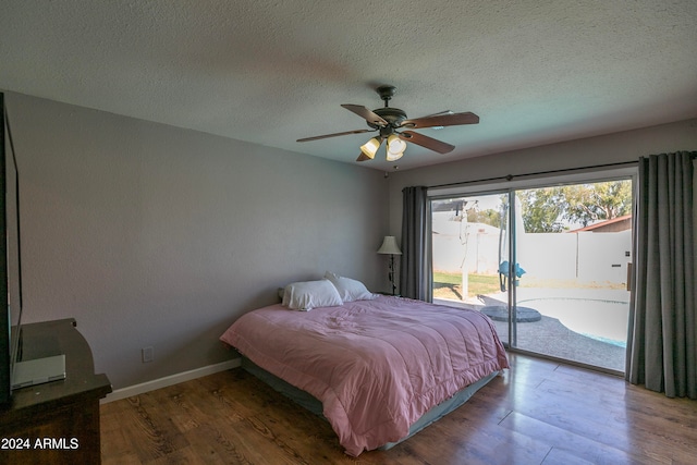 bedroom featuring access to exterior, ceiling fan, wood-type flooring, and a textured ceiling