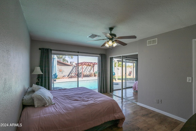 bedroom featuring access to outside, hardwood / wood-style floors, multiple windows, and ceiling fan