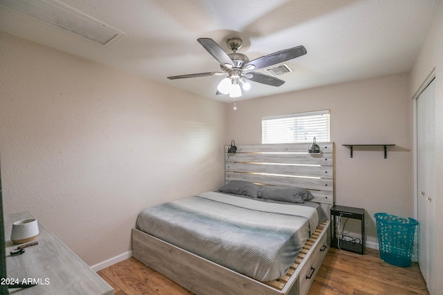 bedroom with ceiling fan, light wood-type flooring, and a closet