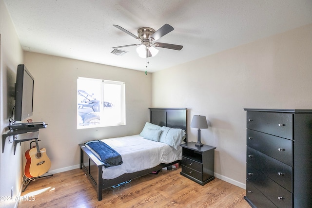 bedroom featuring light hardwood / wood-style floors and ceiling fan