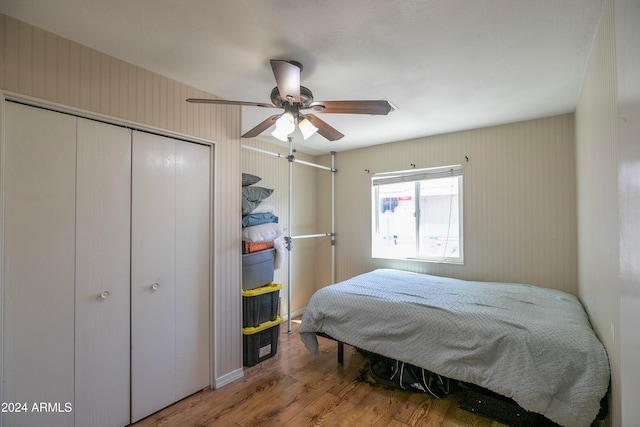 bedroom featuring ceiling fan, a closet, and wood-type flooring