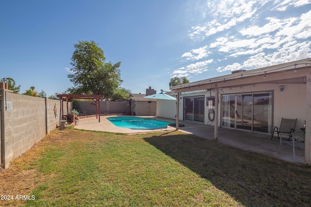 view of yard with a fenced in pool and a patio area