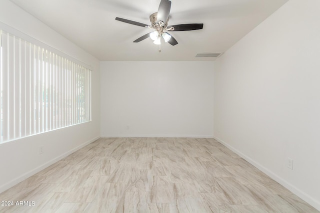 unfurnished room with ceiling fan