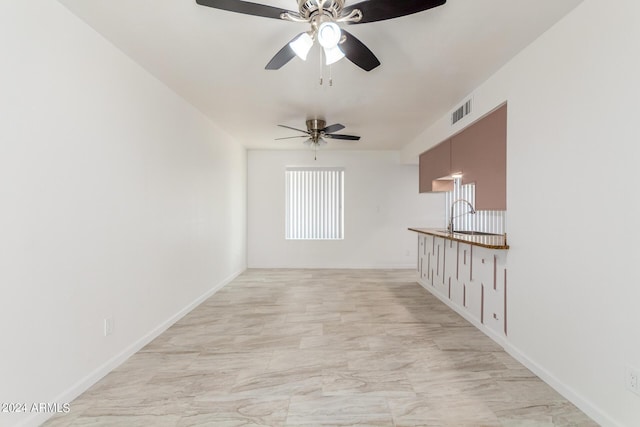 interior space featuring ceiling fan and sink