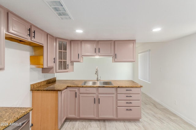 kitchen featuring sink, stone countertops, and light brown cabinets