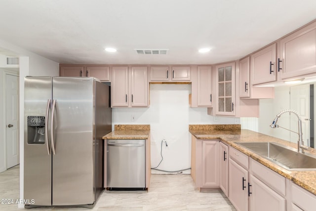 kitchen featuring light brown cabinets, light stone countertops, sink, and appliances with stainless steel finishes