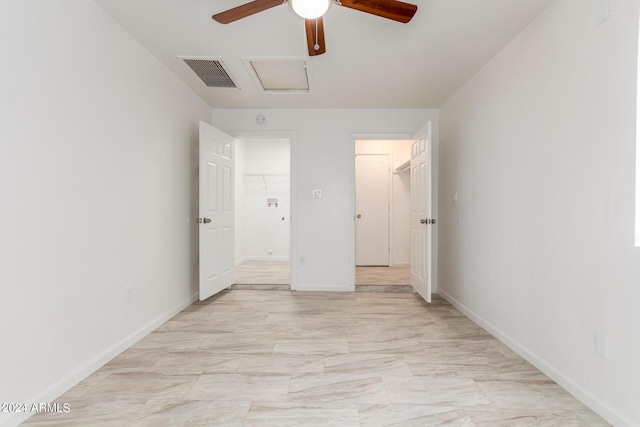 unfurnished bedroom featuring ceiling fan, a spacious closet, and a closet