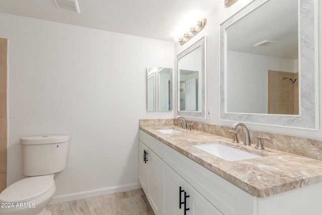 bathroom featuring vanity, toilet, and a shower