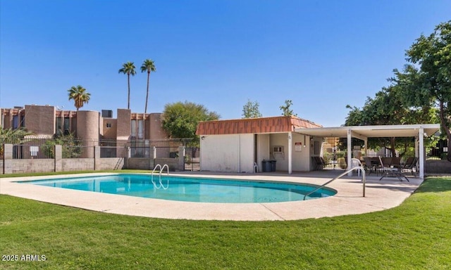 view of pool with a lawn and a patio