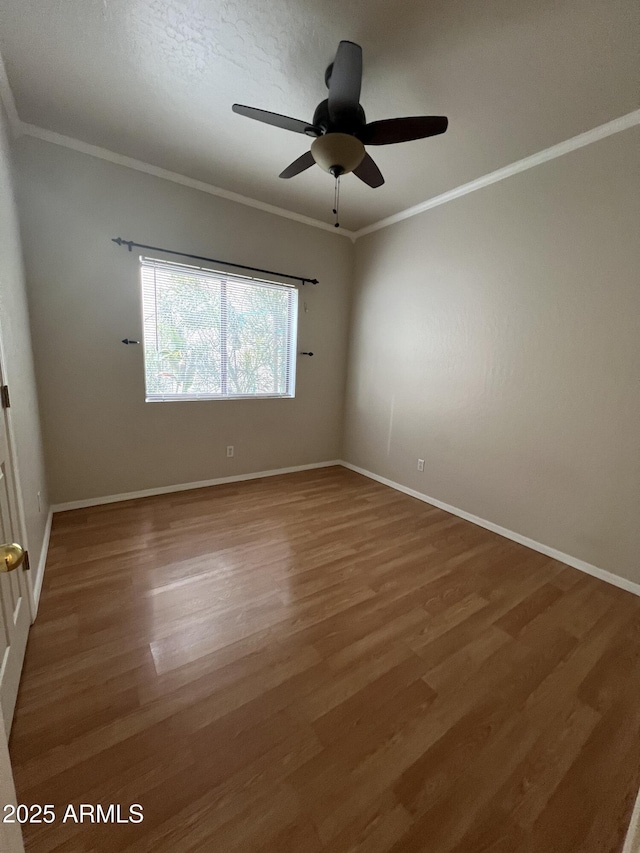 unfurnished room featuring ceiling fan, wood-type flooring, and crown molding